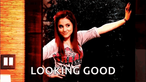 a girl with red hair and a t-shirt that says looking good on it