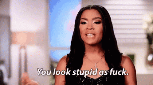 a woman is making a funny face and saying `` you look stupid as fuck . ''