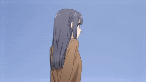 a girl with long dark hair is wearing a brown shirt