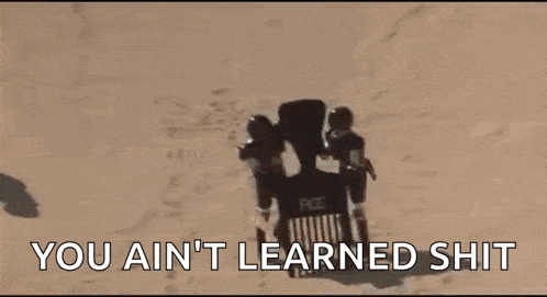 a man in a helmet is holding a gun and saying `` you ain t learned shit '' .