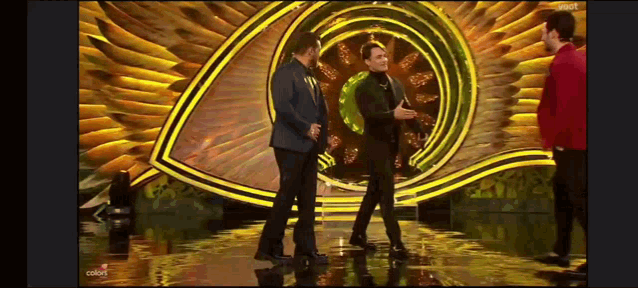 a group of men standing on a stage in front of a large eye .