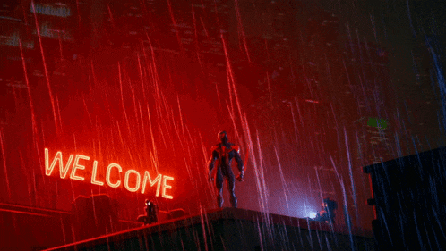 a man stands in front of a red welcome sign