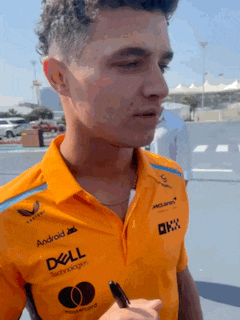 a man wearing an orange shirt with dell and android written on it
