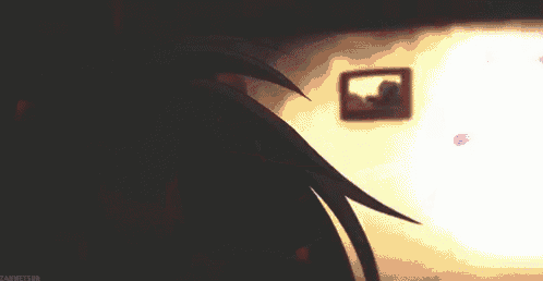 a clock is being displayed on a table in a dark room with a blurred background .