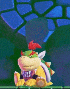 a cartoon character named bowser is sitting on a green surface .