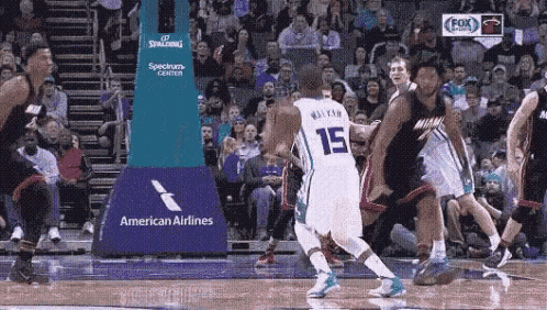 a basketball game is being played in front of an american airlines banner