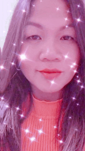 a close up of a woman 's face with sparkles on her face