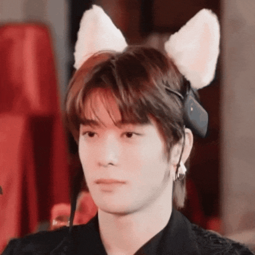 a close up of a person wearing a cat ear headband