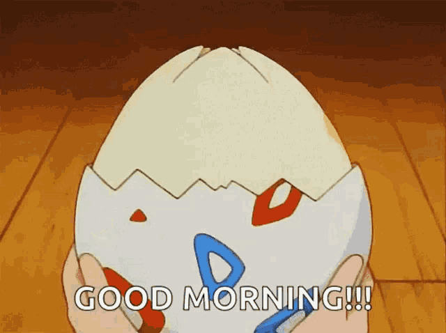 a person is holding a broken egg in their hands and saying good morning .