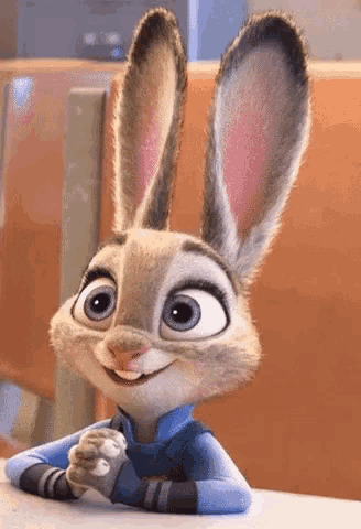 a cartoon rabbit is sitting at a table and smiling .