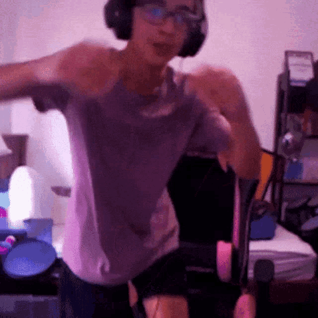 a person wearing headphones and a purple shirt dancing