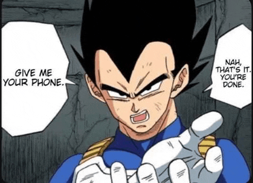 vegeta from dragon ball z is holding a cell phone in his hand and talking to someone .