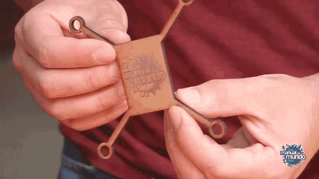 a person is holding a piece of wood that says libertad y justicia