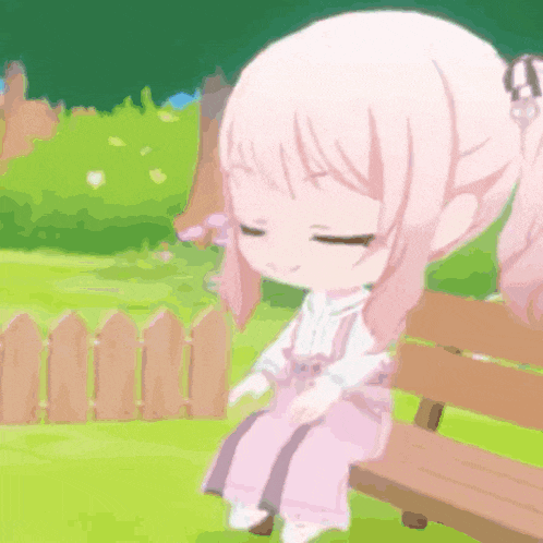 a girl with pink hair is sitting on a bench in a park .