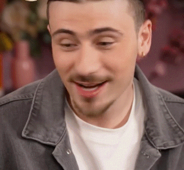 a close up of a man 's face with a denim jacket on
