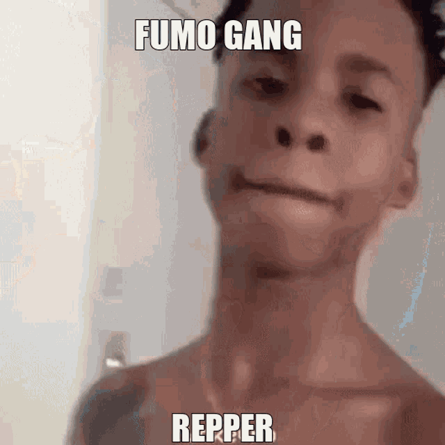 a young man without a shirt is taking a selfie with a caption that says `` fumo gang repper '' .