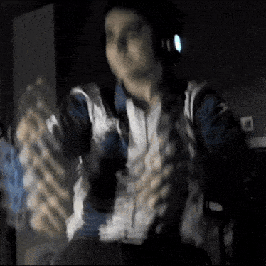 a blurry picture of a person wearing headphones and a shirt that says ' avengers ' on it