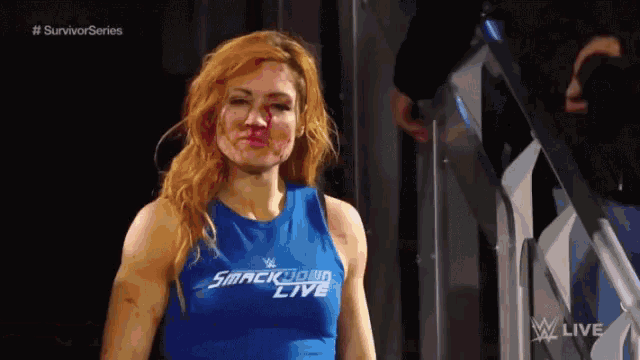 a woman wearing a blue smackdown live tank top