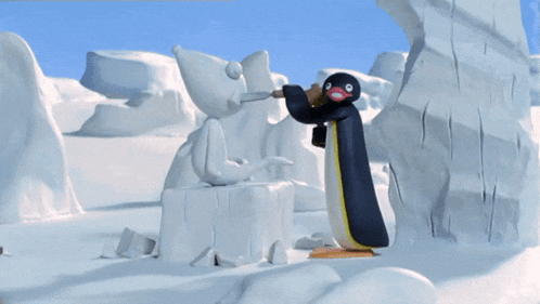 a penguin is holding a hammer next to a statue of a mouse