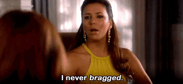 a woman in a yellow top is talking to another woman and says `` i never bragged '' .