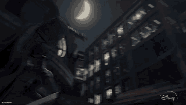a disney + ad shows a city at night with a crescent moon