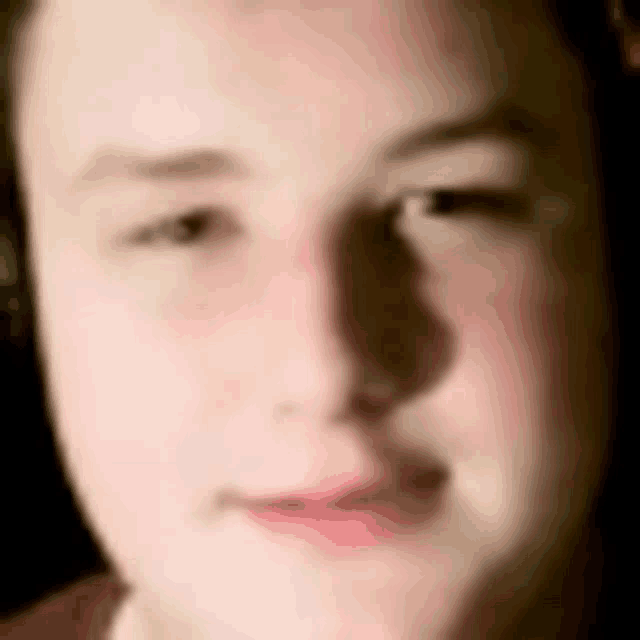 a close up of a young man 's face with his eyes closed .