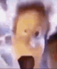 a close up of a person 's face with a microphone in front of them .