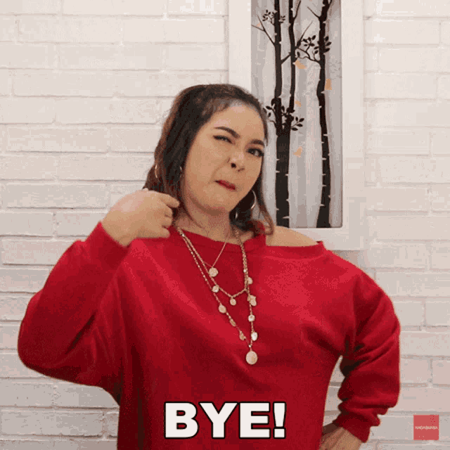 a woman in a red shirt says bye
