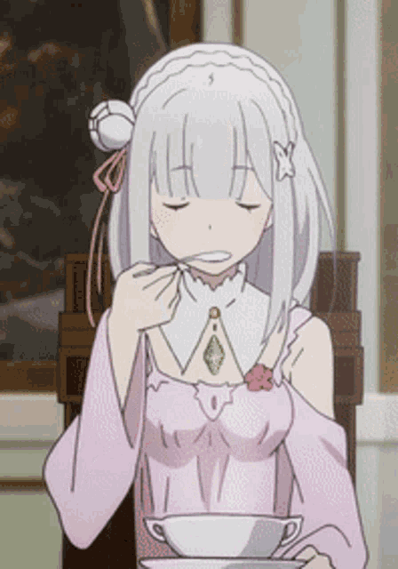 a girl with white hair is sitting in a chair eating from a cup