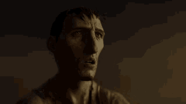 a close up of a man 's face with a serious expression