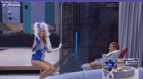 a woman in a blue costume is dancing in front of a man