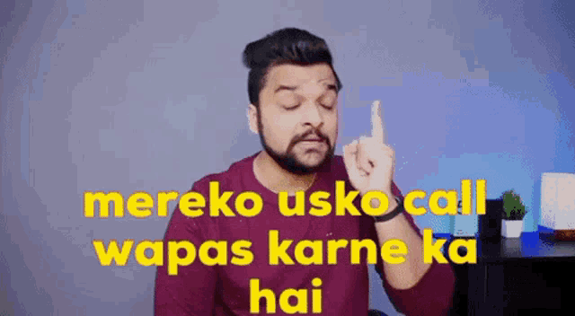 a man with a beard is giving the middle finger and the words mereko usko call wapas karne ka hai are behind him