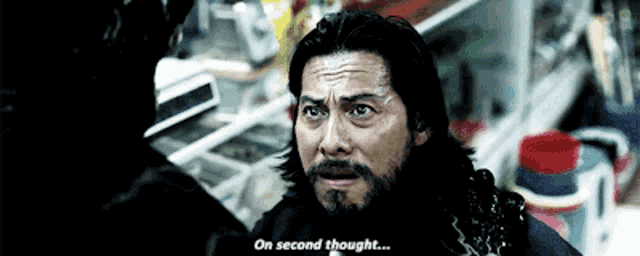 a man with a beard is talking to another man and says on second thought