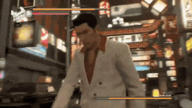 a man in a white suit is playing a video game on a computer .