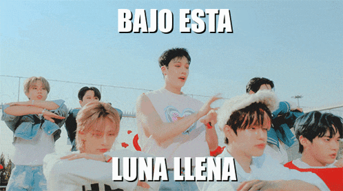 a group of young men are dancing with the words bajo esta luna llena written above them