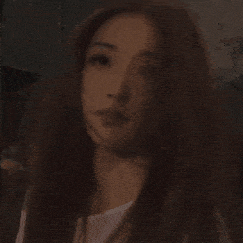 a woman with long hair is holding a white cup in her hand .