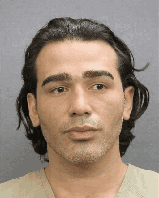 a close up of a man 's face with long hair