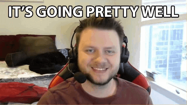 a man wearing headphones is smiling with the words it 's going pretty well above him