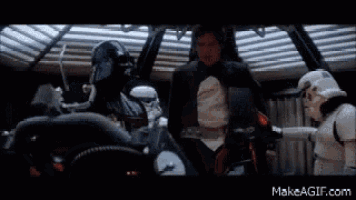 darth vader , han solo , and stormtroopers are standing next to each other in a room .