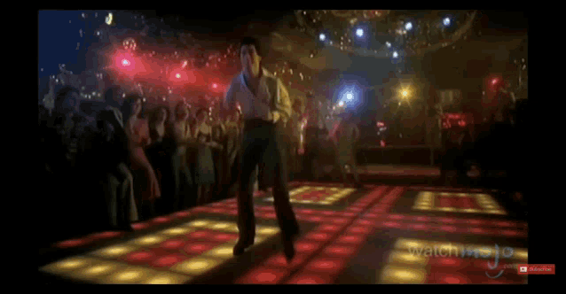 a man is dancing on a dance floor in front of a crowd with a subscribe button
