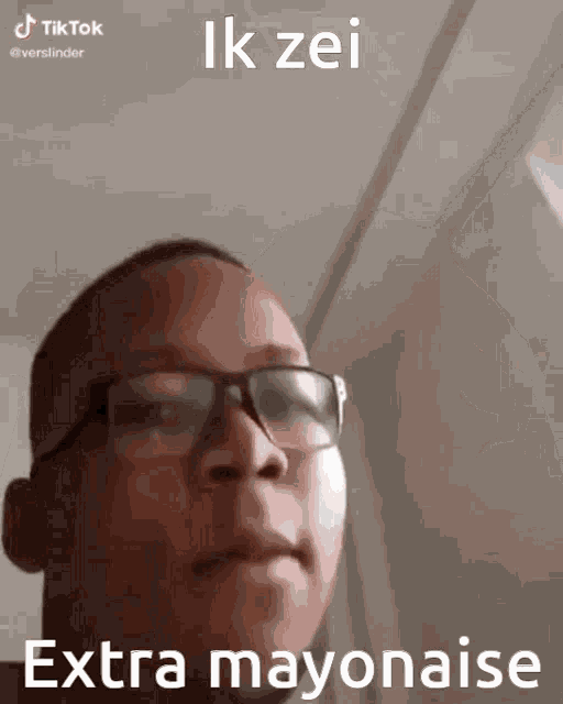 a man wearing glasses says extra mayonaise on the bottom of his face