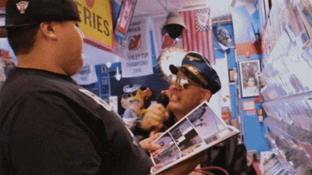 a man holding a book in front of a sign that says fries on it