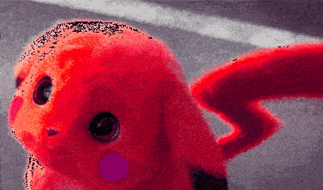 a close up of a red stuffed animal with a purple nose and tail