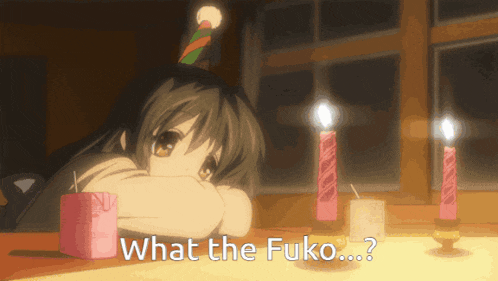 a girl wearing a party hat is sitting at a table with candles and the words what the fuko