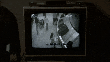 a black and white tv screen shows the time of 5:23 05