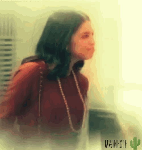 a blurry picture of a woman with a mainegif cactus in the corner