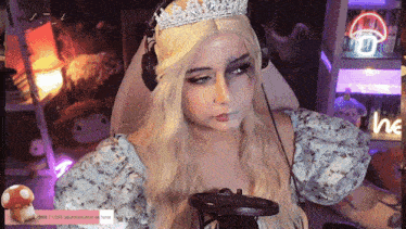 a woman wearing a crown and headphones looks at the camera