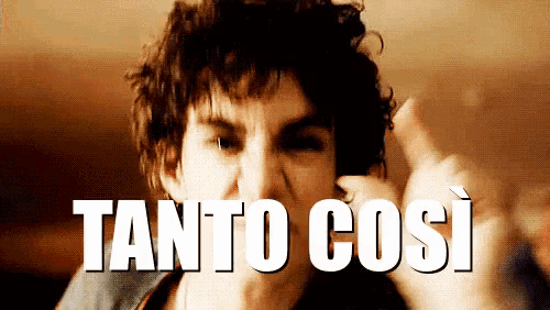 a man with curly hair is pointing at the camera with the words " tanto così " below him