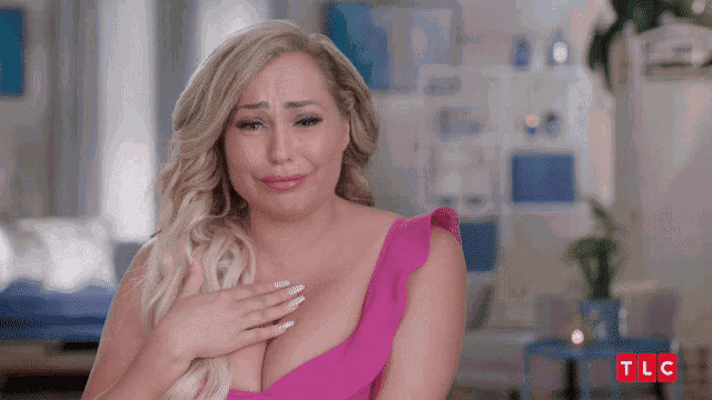a woman in a pink dress is crying with tlc written in red