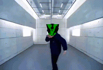 a person with a green mask on their head is walking through a hallway